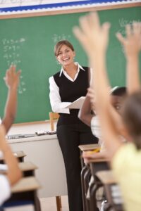 Teacher teaching her students at school